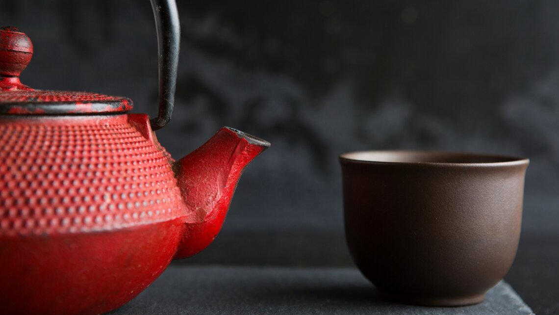 Red iron tea pot with tea bowl